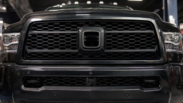 Ram 2500 front grille detail with camera and parking-sensor fitment areas visible.