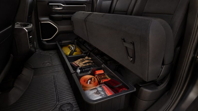 Ram rear-cab under-seat organizer loaded with tow and emergency gear.